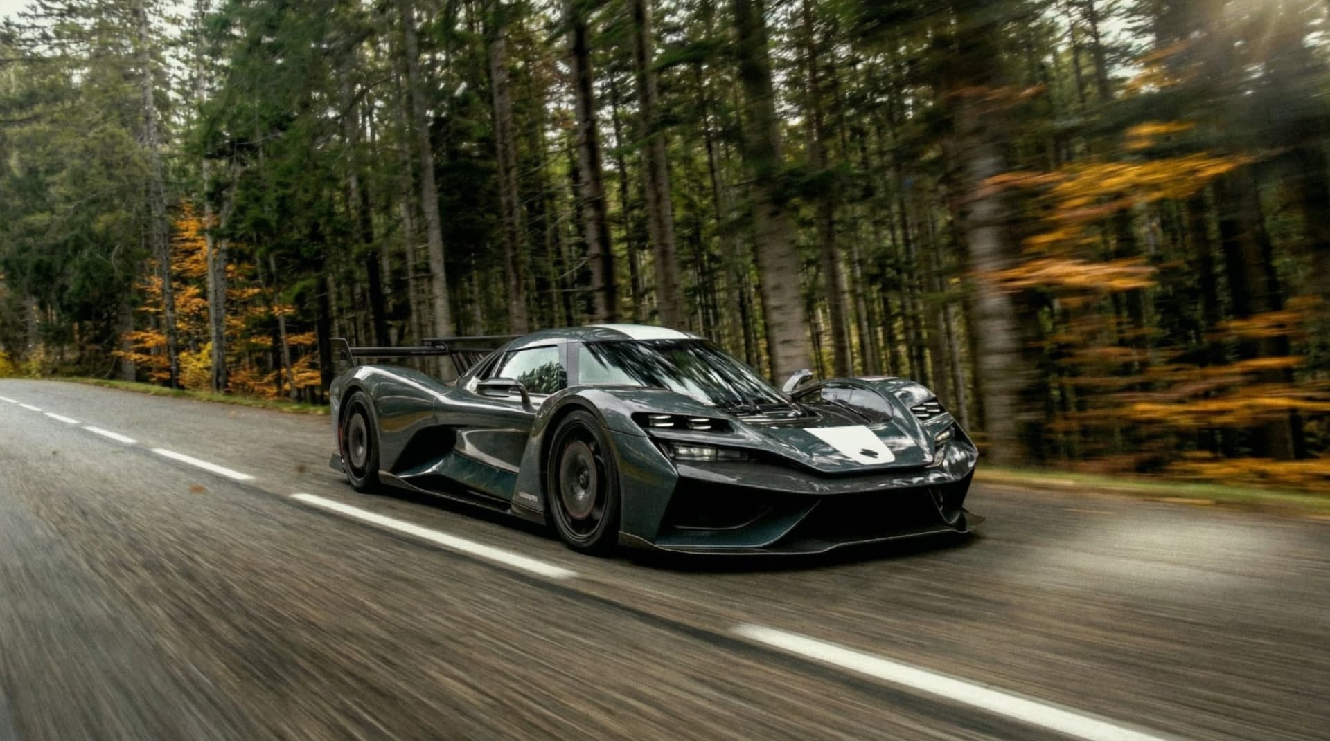 LA1 racing through an autumn forest road